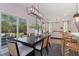 Open-concept dining area adjacent to living room with modern table, chairs, and sliding patio doors at 135 Willow Cameron Way, Angier, NC 27501