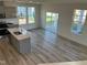 Kitchen and dining area with hardwood floors and a sliding glass door at 135 Willow Cameron Way, Angier, NC 27501