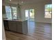 Bright kitchen with a central island, sliding glass doors, and hardwood flooring at 135 Willow Cameron Way, Angier, NC 27501