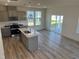 Modern kitchen with stainless steel appliances, island, and light gray cabinets at 135 Willow Cameron Way, Angier, NC 27501