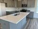 Kitchen featuring a large island with a sink, stainless steel appliances, and ample counter space at 135 Willow Cameron Way, Angier, NC 27501