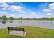 Picturesque view of the lake from a bench, providing a tranquil and inviting outdoor space at 135 Willow Cameron Way, Angier, NC 27501