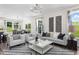 Bright, spacious living room with stylish furniture, large windows, and views into the dining area at 135 Willow Cameron Way, Angier, NC 27501