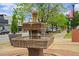 A stone fountain is the focal point of this Angier, North Carolina street scene featuring a quaint water feature at 135 Willow Cameron Way, Angier, NC 27501