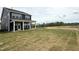Scenic view of the backyard featuring a covered porch, lush lawn and beautiful landscaping at 136 Willow Cameron Way, Angier, NC 27501