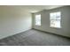 Carpeted bedroom with natural light streaming through two windows at 136 Willow Cameron Way, Angier, NC 27501