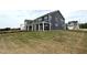 New two-story home showing a well-manicured lawn and spacious covered back porch at 136 Willow Cameron Way, Angier, NC 27501