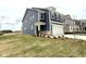 Beautiful new construction home showing the front and side of the yard and stone-lined garage at 136 Willow Cameron Way, Angier, NC 27501