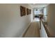 Hallway features neutral paint, plush carpet and leads to a bonus room at 136 Willow Cameron Way, Angier, NC 27501