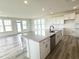 Open kitchen featuring a center island with seating, stainless steel appliances, and ample counter space at 136 Willow Cameron Way, Angier, NC 27501