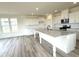 Bright kitchen with quartz counters, a large center island, and stainless steel appliances at 136 Willow Cameron Way, Angier, NC 27501