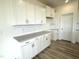 A modern kitchen features white cabinets, white subway tile, and stainless steel accents at 136 Willow Cameron Way, Angier, NC 27501