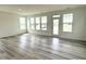 Sun-filled living room with large windows and durable hardwood floors at 136 Willow Cameron Way, Angier, NC 27501