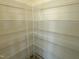 A walk-in pantry features metal shelving and tons of storage space at 136 Willow Cameron Way, Angier, NC 27501