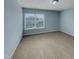 Cozy bedroom with neutral walls, plush carpeting, and a bright window at 151 N Great White Way, Clayton, NC 27527