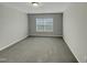 Bedroom with neutral walls, plush carpeting, a bright window, and ceiling light at 151 N Great White Way, Clayton, NC 27527