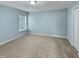 Bedroom with plush carpeting and a window that provides natural light at 151 N Great White Way, Clayton, NC 27527