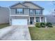 Charming two-story home featuring stone accents, a two-car garage, and a well-maintained front yard at 151 N Great White Way, Clayton, NC 27527
