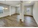 Open-concept living room with wood-look floors and decorative columns at 151 N Great White Way, Clayton, NC 27527