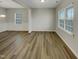 Spacious room with wood-look floors and large windows for natural light at 151 N Great White Way, Clayton, NC 27527