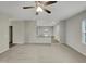 Open-concept living room with neutral carpet, flowing into the kitchen with eat-in bar at 151 N Great White Way, Clayton, NC 27527