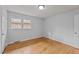 Well-lit bedroom featuring hardwood floors, complemented by large windows at 1721 Fountain St, Rocky Mount, NC 27801