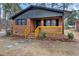 Brick home features a black roof and shutters, along with a bright yellow porch at 1721 Fountain St, Rocky Mount, NC 27801