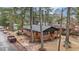 Aerial view showcasing a charming brick home with a cozy porch, set among mature trees and a quiet street at 1721 Fountain St, Rocky Mount, NC 27801