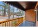 Front porch with a brick facade, wood railings, and dark ceilings at 1721 Fountain St, Rocky Mount, NC 27801