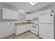 Functional kitchen area with natural light, laminate floors and white appliances at 1721 Fountain St, Rocky Mount, NC 27801