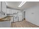 Functional kitchen area with natural light, laminate floors, white cabinets and appliances at 1721 Fountain St, Rocky Mount, NC 27801