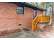 Side entrance of a brick home with wooden stairs and railings at 1721 Fountain St, Rocky Mount, NC 27801