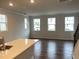 Sunlit living room with hardwood floors and a view of the kitchen island at 2005 Sequoia Ln, Durham, NC 27703