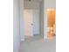 Hallway view of a bathroom with a toilet, shower and tile surround at 2100 Curry Meadow Way, Durham, NC 27703