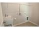 A utility room featuring a utility sink and a wire rack shelf at 2100 Curry Meadow Way, Durham, NC 27703