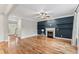 Open-concept living room with a charming fireplace and rich hardwood floors at 215 W Delafield Ave, Durham, NC 27704