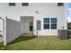 Home exterior with manicured lawn, white fence, and backyard access at 220 Starlight St, Sanford, NC 27330