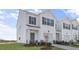 Charming townhome featuring a two-car garage, white siding, and a well-manicured lawn at 220 Starlight St, Sanford, NC 27330