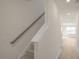 Bright hallway featuring white trim and a staircase with a gray banister at 220 Starlight St, Sanford, NC 27330