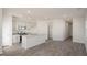 Open concept space features modern kitchen with island, recessed lighting, with luxury vinyl plank floors throughout at 220 Starlight St, Sanford, NC 27330