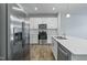 Bright kitchen featuring stainless steel appliances, white cabinetry, and a center island, offering a modern and functional space at 227 Liam St, Clayton, NC 27520