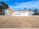 Spacious brick home features a large white deck overlooking the expansive backyard on a sunny day at 2420 New Bethel Church Rd, Garner, NC 27529