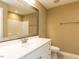 Bathroom featuring a large mirror, toilet and vanity with sink, neutral tones and tile flooring at 2420 New Bethel Church Rd, Garner, NC 27529