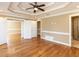 Bedroom showcasing hardwood floors, a tray ceiling, multiple doorways to adjacent rooms at 2420 New Bethel Church Rd, Garner, NC 27529