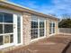 Lovely deck with a brick facade, glass door entry, and large windows at 2420 New Bethel Church Rd, Garner, NC 27529