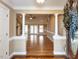 Elegant foyer with hardwood floors, decorative columns, and an open view to the living area at 2420 New Bethel Church Rd, Garner, NC 27529