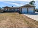 Charming brick home featuring a covered porch, two-car garage, and a well-maintained front yard at 2420 New Bethel Church Rd, Garner, NC 27529