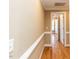 Hallway with hardwood flooring, crown molding, and doorways leading to other rooms at 2420 New Bethel Church Rd, Garner, NC 27529