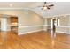 Open-concept living room with hardwood floors, a fireplace, and views to the kitchen and entry at 2420 New Bethel Church Rd, Garner, NC 27529
