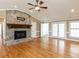 Bright living room with hardwood floors, a stone fireplace, and French doors leading to the outside at 2420 New Bethel Church Rd, Garner, NC 27529